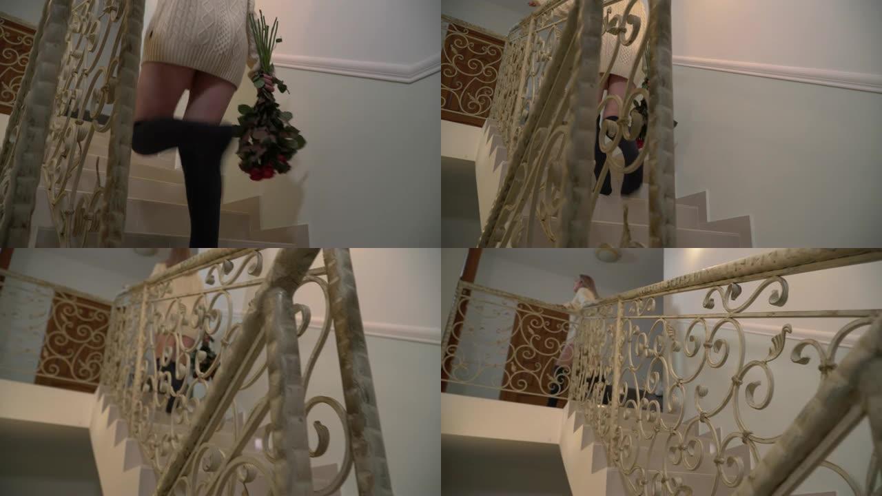 一个拿着花束的女孩爬上楼梯。一个穿着短冬季毛衣和长袜的年轻女子上了楼梯。