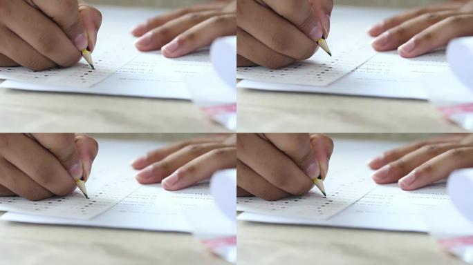 亚洲学生在学习在线学习或通过笔记本电脑进行电子学习时在笔记本上注明。女商人为木桌办公室的规划工作写作