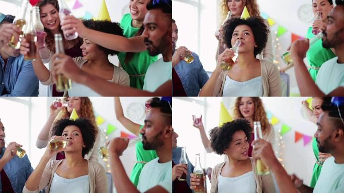 在办公室聚会上喝酒庆祝的快乐团队