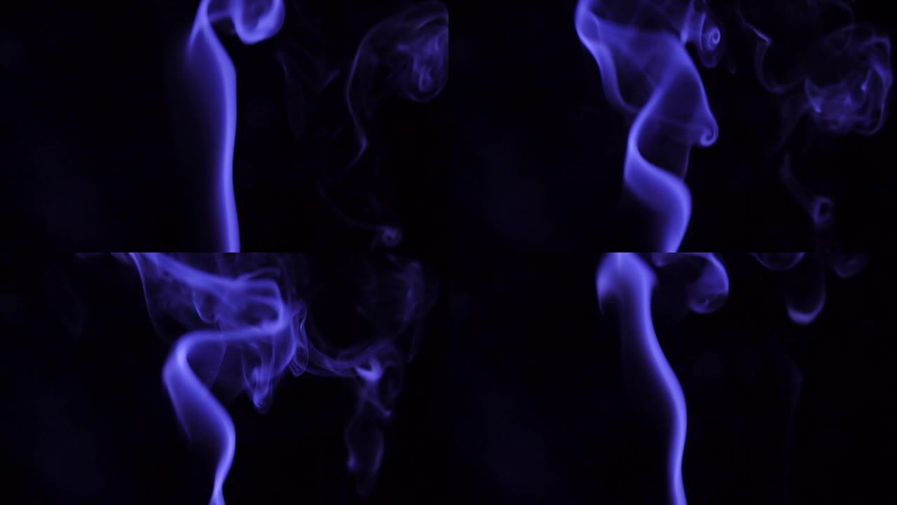 蓝色蒸汽从上升。黑色背景上的蓝色烟雾。黑色背景下的烟雾慢慢漂浮在太空中。慢动作。