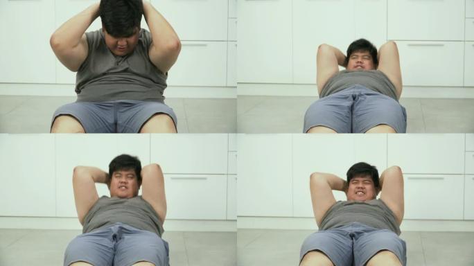 前视图: 超重男子在厨房锻炼和仰卧起坐