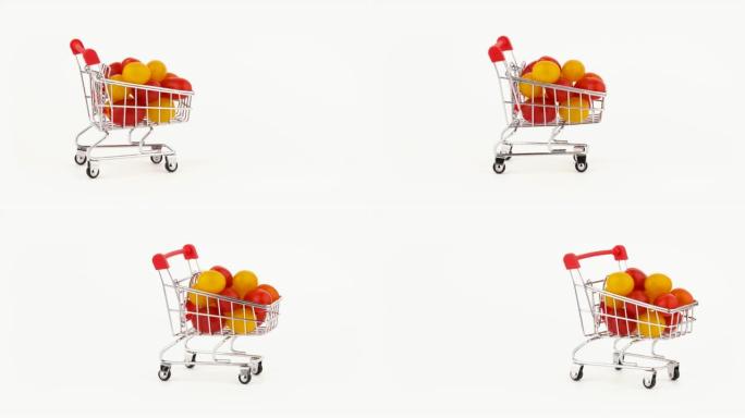 移动超市手推车装满了红色和黄色的葡萄西红柿堆。孤立在白色背景上。特写。宏观。