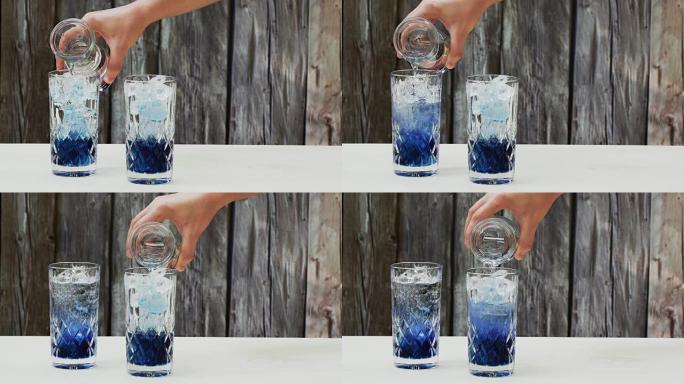 把苏打水倒在蓝豌豆花茶浓缩糖浆上(Clitoria Ternatea)