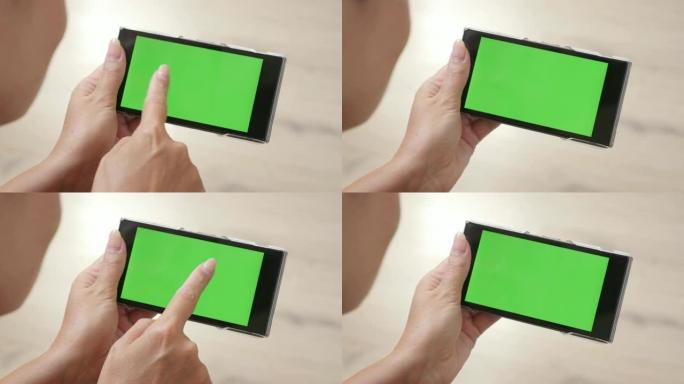 带绿屏智能手机的女人在家放松4K 2160p 30fps超高清镜头 -- 女性躺在地板上，拿着绿屏显