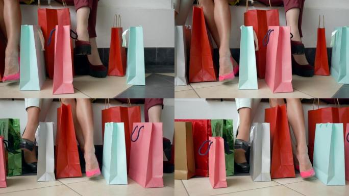 购物日，在折扣和销售季节，时尚女孩的脚步与许多彩色购买包
