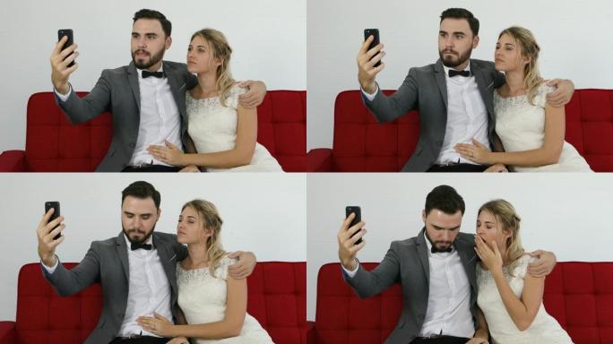 新婚夫妇快乐开朗的夫妇拍摄智能手机自拍照片并微笑