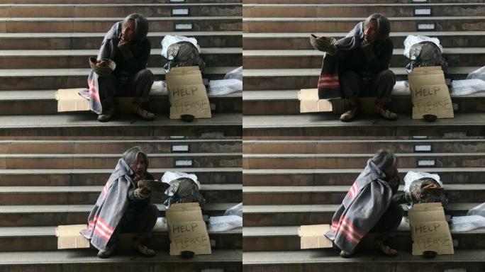 无家可归的人坐在楼梯上乞讨人们