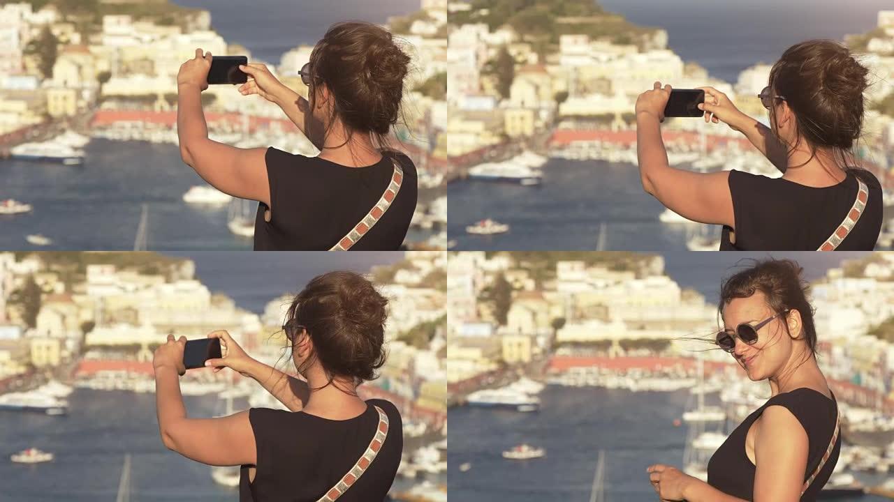快乐的年轻女性游客在意大利传统海城景观的蓬扎岛上拍摄智能手机照片