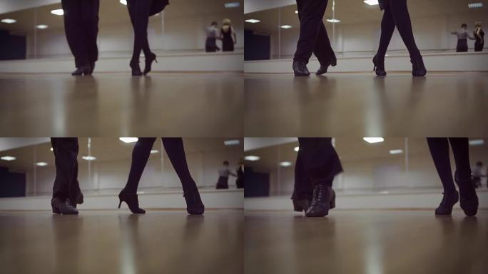 在舞蹈工作室跳舞的男女腿