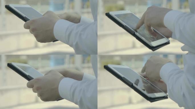 男性手指快速触摸平板电脑屏幕的特写镜头