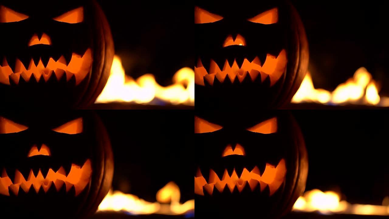 万圣节的可怕象征-杰克-o-灯笼。地狱火焰中可怕的南瓜头。半个橘子葫芦在左边。容光焕发的脸，不给糖就