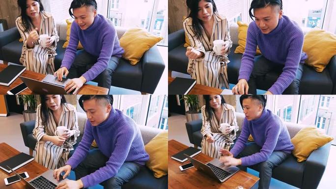 年轻的台湾企业家在笔记本电脑上进行团队合作