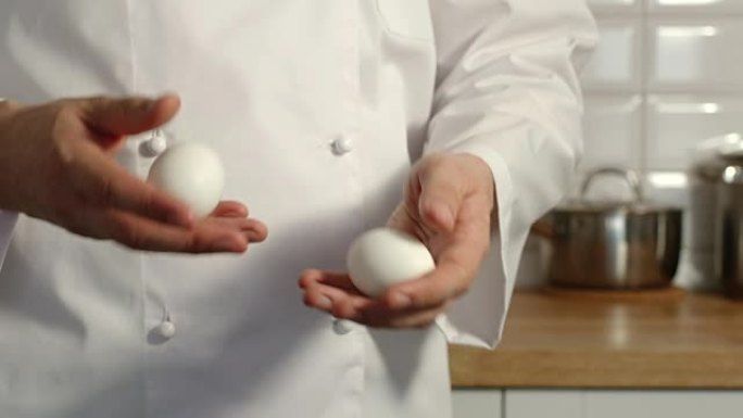 特写: 首席炊具在厨房里玩鸡蛋-慢动作