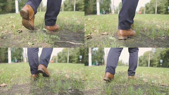 脚和老式鞋子在草地上