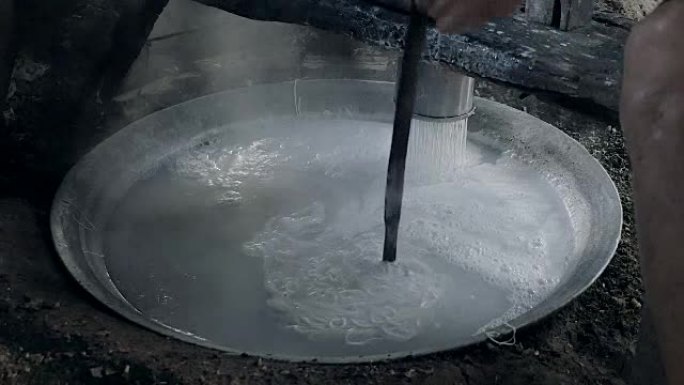 传统的米粉制作用压榨机将米粉切成条状