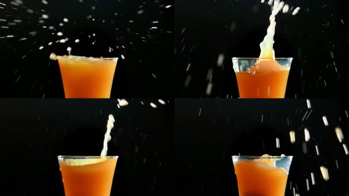 黑色背景下的橙汁飞溅
