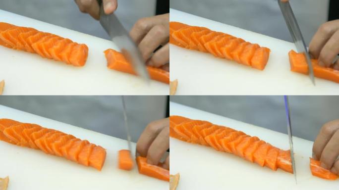 餐厅的厨师将生鱼切成鲑鱼寿司和生鱼片
