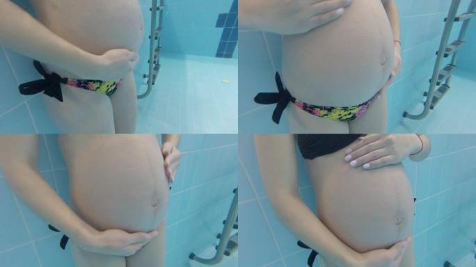 怀孕的女孩在游泳池水下游泳。