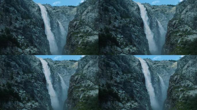山中巨大的瀑布，一股强大的水流从岩石上落下，慢动作