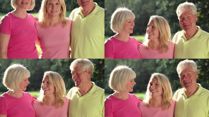 婴儿潮一代和女儿在公园里对着镜头微笑。中枪。