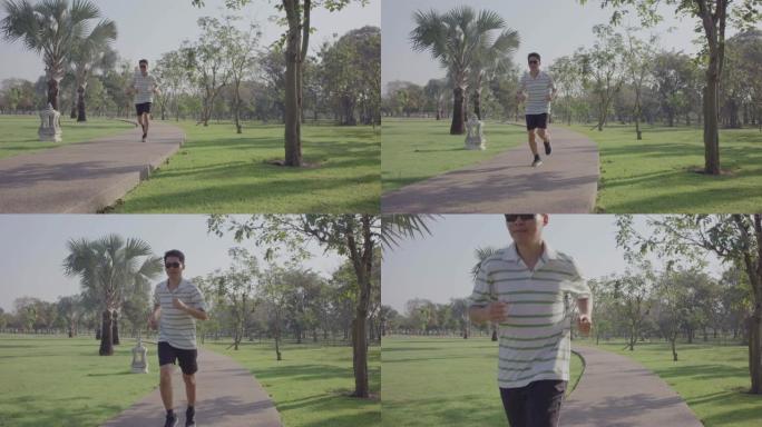 戴着墨镜的男人在公园慢跑，4k slo mo
