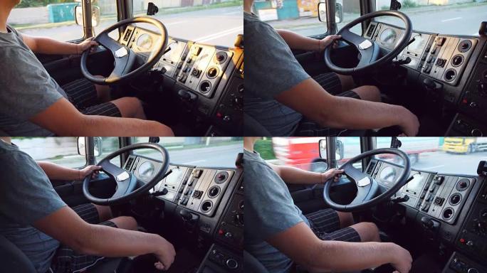 面目全非的人把手放在方向盘上，在城市道路上驾驶卡车。卡车司机的手臂。卡车司机乘车前往目的地。从驾驶室