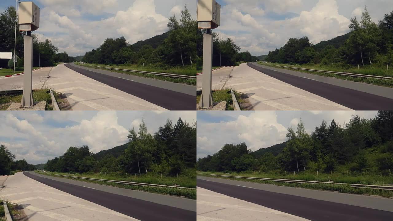 一条没有汽车的高速公路，路边有测速摄像头和雷达