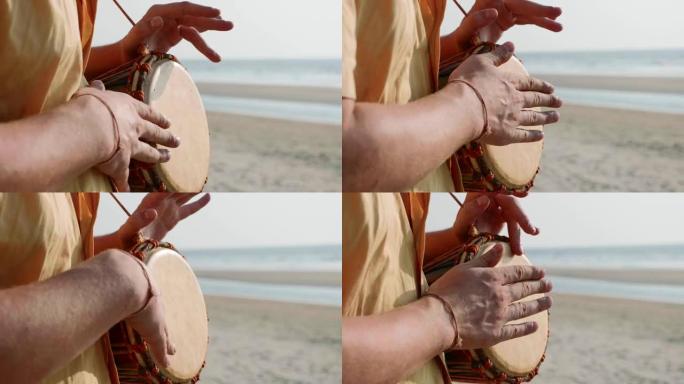 男人用手打鼓，特写。双手敲击小鼓