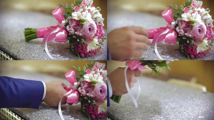 新郎为新娘拿结婚戒指和鲜花。庆祝活动的准备。特写。