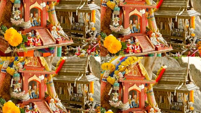 木制微型守护者精神屋。小佛寺神龛，五颜六色的花环。圣帕·普姆 (San phra phum) 树立了