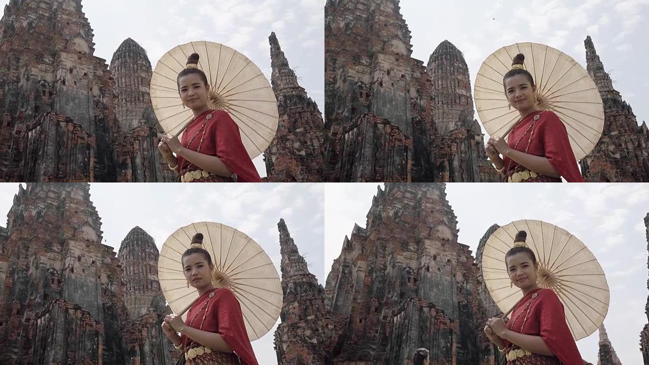 泰国年轻女子穿着泰国民族礼服套装在大城府老庙散步
