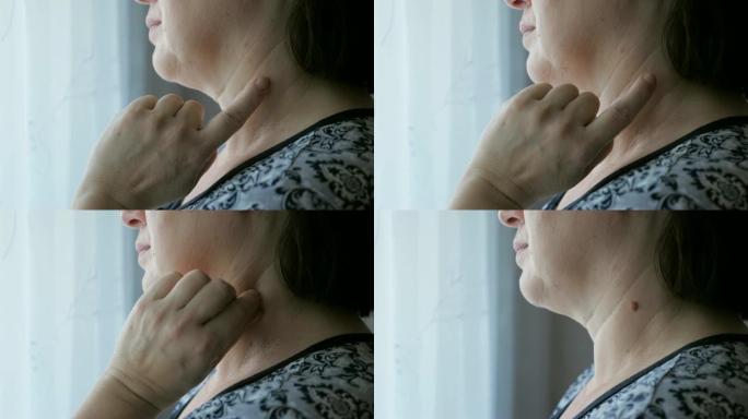 女人触摸脖子上的痣的特写镜头