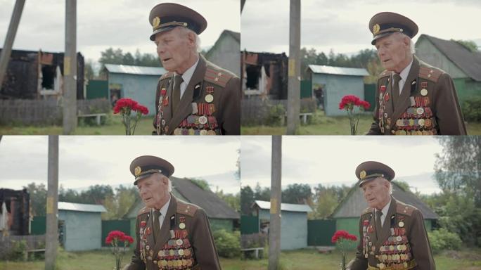 一位上了年纪的灰白头发的老兵，参加过伟大的卫国战争和第二次世界大战，穿着制服，佩戴着许多徽章和命令穿