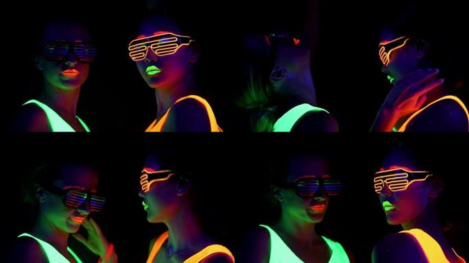 女人用UV面漆，发光的衣服，发光的手镯，在镜头前跳舞的眼镜，脸部拍摄。高加索人和女人。。