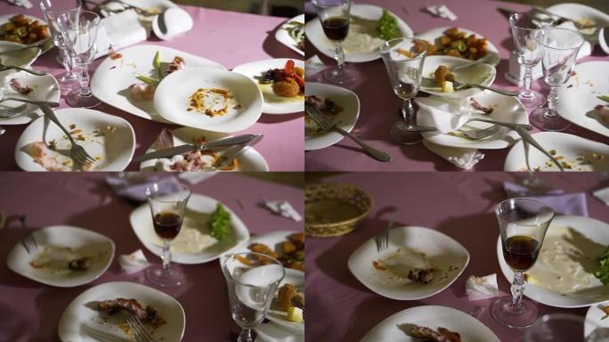 餐厅桌子上剩下的食物和脏盘子。