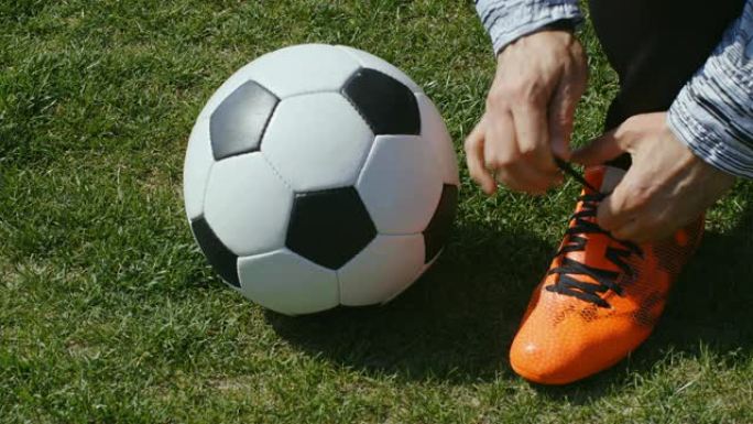 足球，足球比赛。职业足球运动员在训练前扣上红鞋，4k