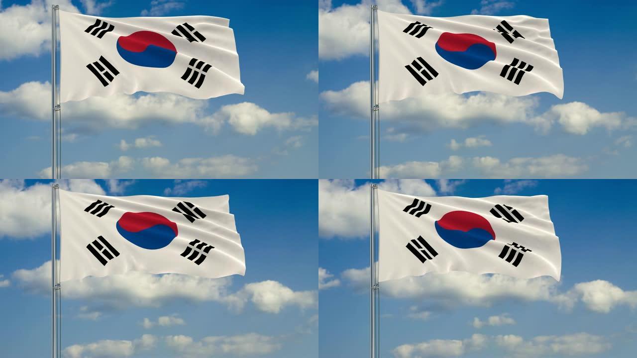 韩国国旗映衬着漂浮在蓝天上的云朵