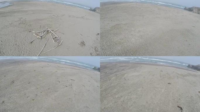 无人机在沙滩上飞向海洋