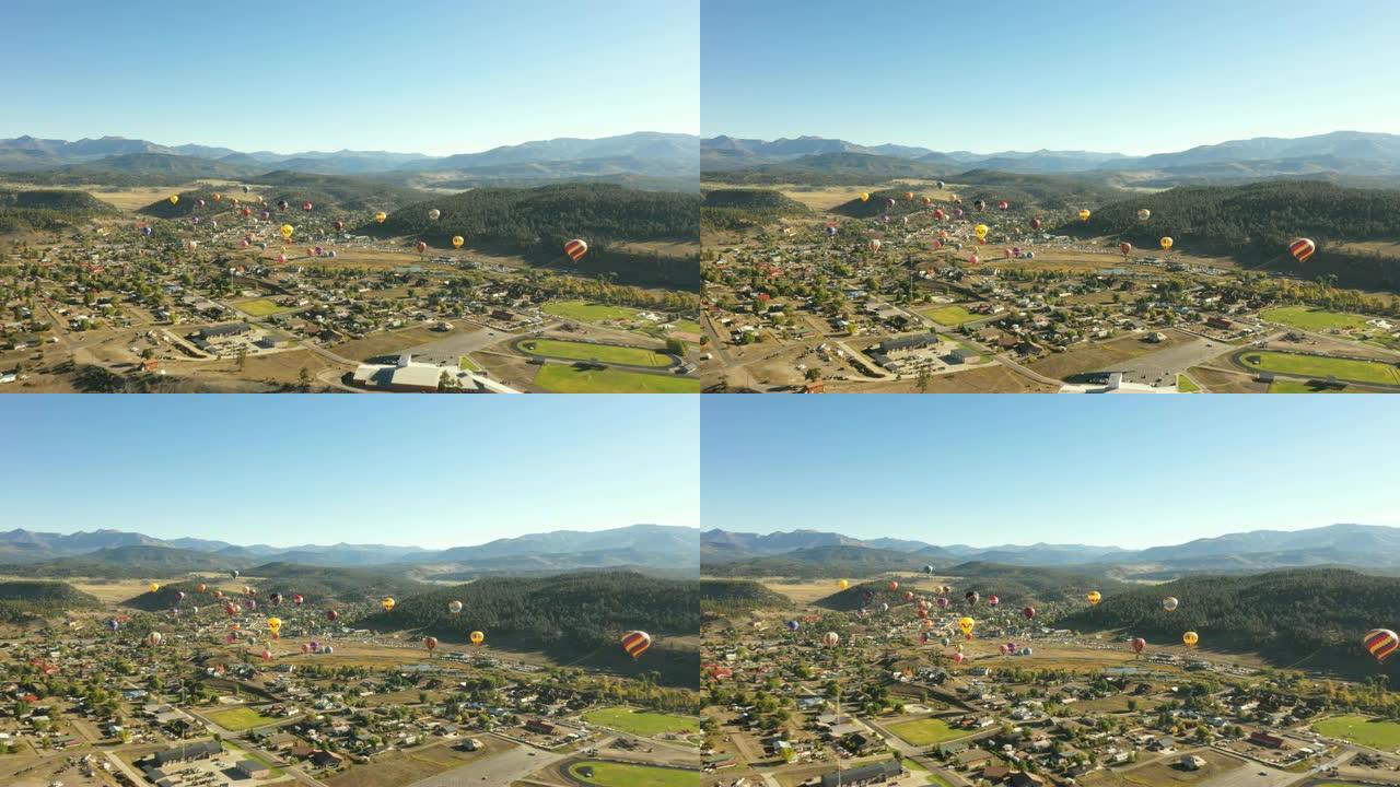 许多热气球在乡村小镇上空升起
