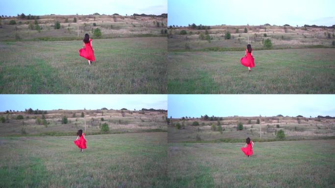 一位穿着红色连衣裙在野外奔跑的美丽女士