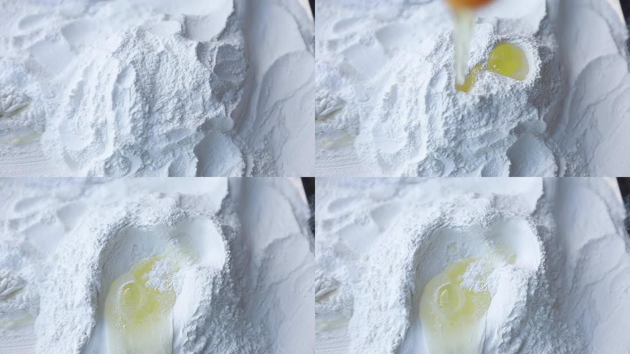慢动作将鸡蛋放入面粉中