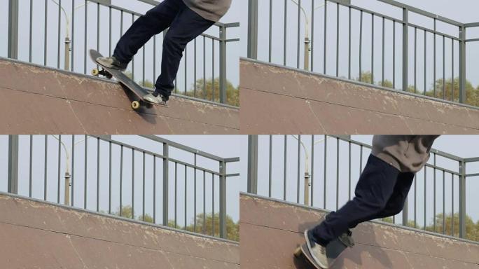 溜冰者在木制迷你坡道的边缘做漂亮的旋转技巧，慢动作