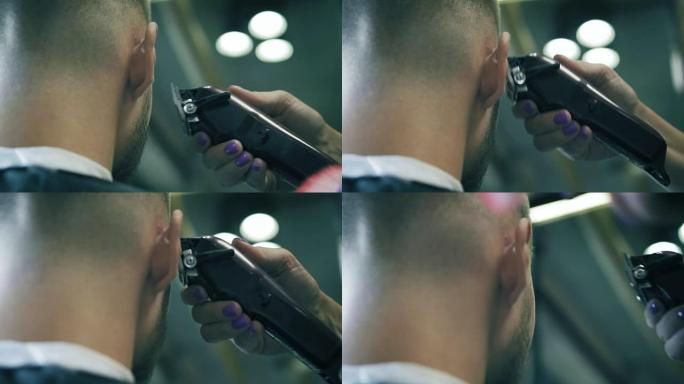 在理发店用修剪器近距离观察男人的发型和剃须。专业理发师在理发店做胡须造型。慢动作