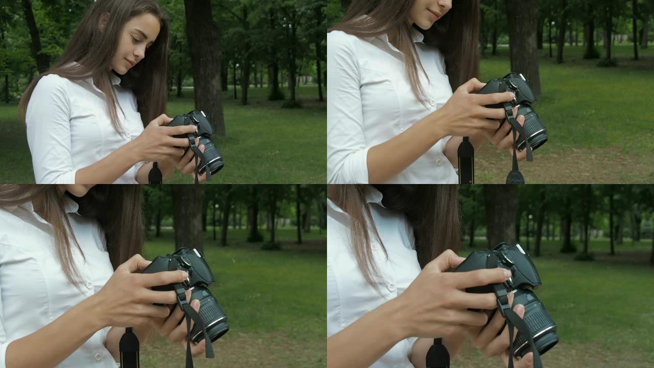 女孩透过相机里的照片看。