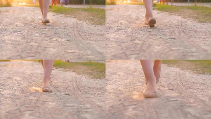 穿着平底鞋的女人脚走在尘土飞扬的小路上