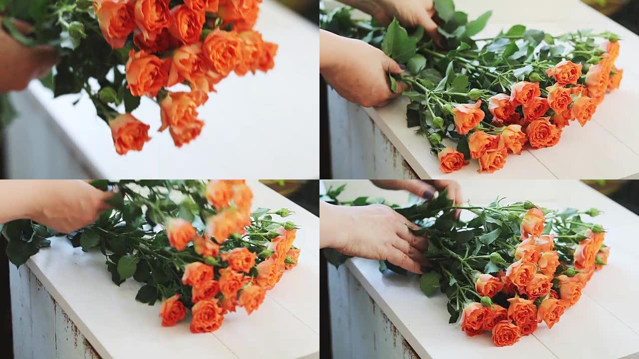 专业女性花卉艺术家，花店在花店车间用丝带包裹美丽的花束。花艺、手工制作和小型企业概念。