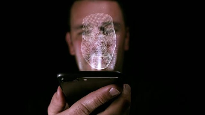 男性拿着一个数字设备，脸上有3D印记作为全息图。面部识别和身份概念