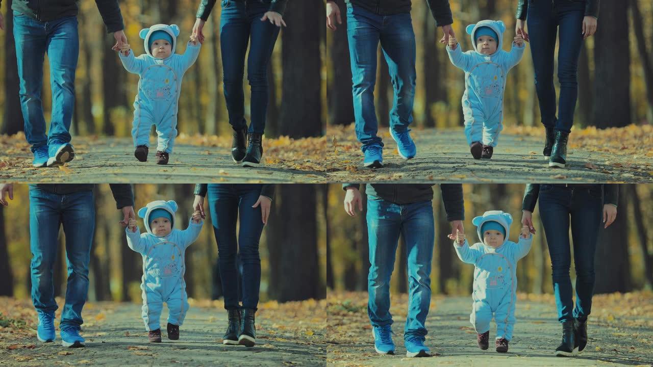 与宝宝牵手的父母在秋园散步