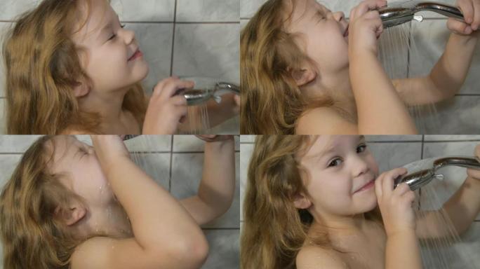 一个女婴在浴室里用淋浴器洗她的头