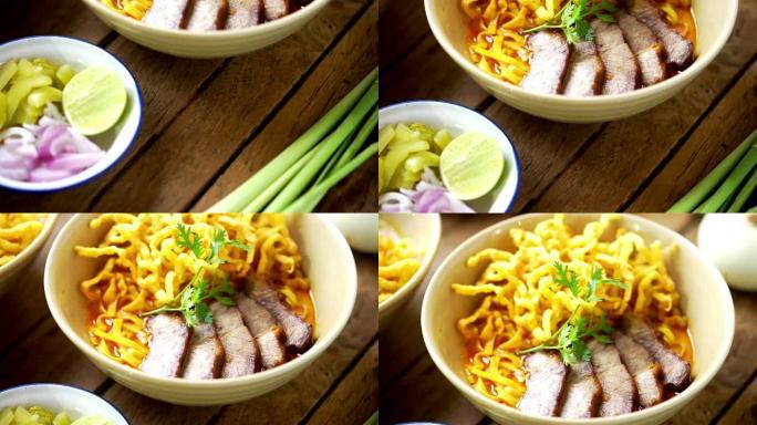 倾斜相机: Khao Soi食谱，泰国北部风味咖喱面汤和猪肉放在木桌上。